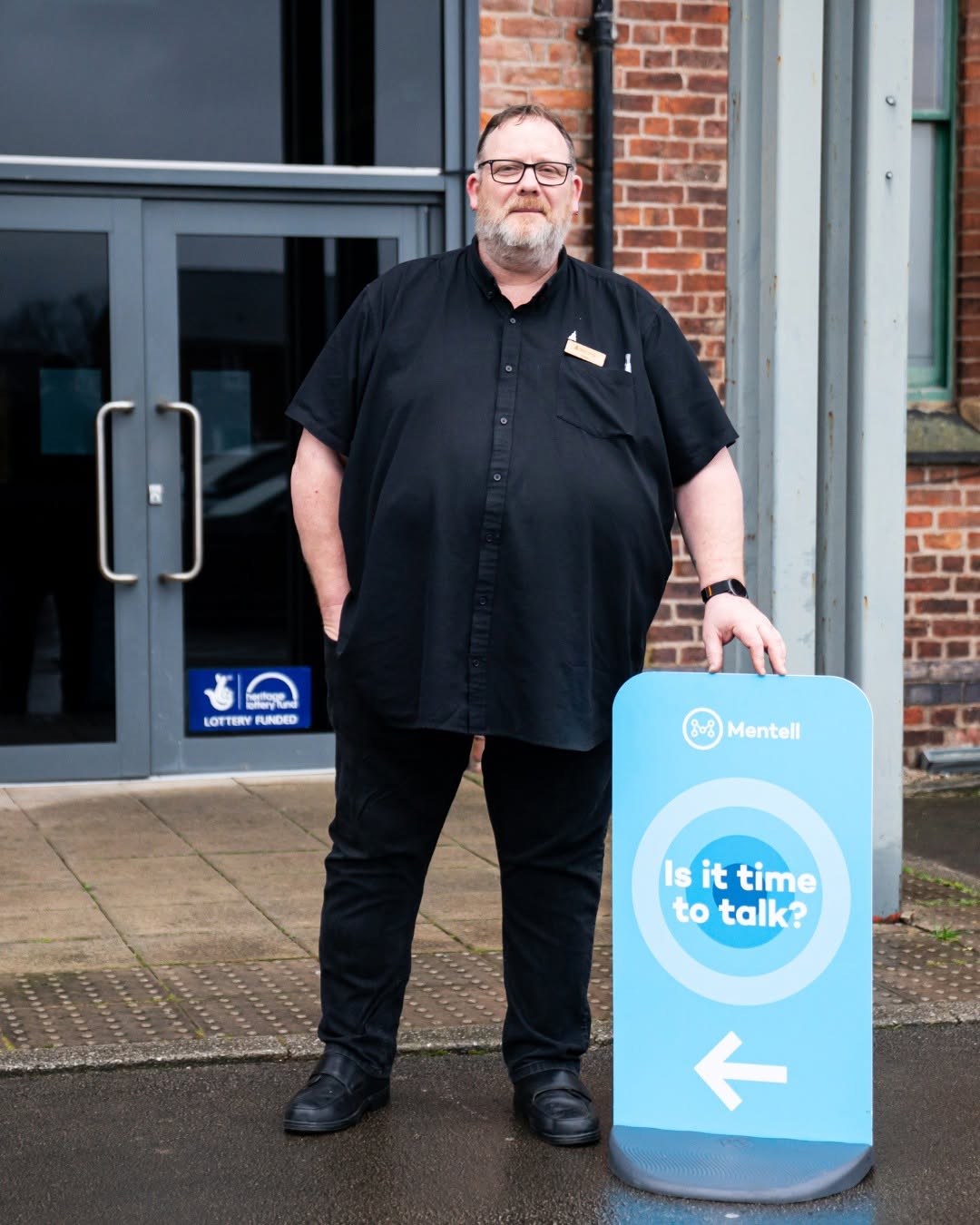 Chris Kennedy – facilitator of Mentell Gorton, stands outside the entrance to the weekly meeting at The Monastery Manchester.