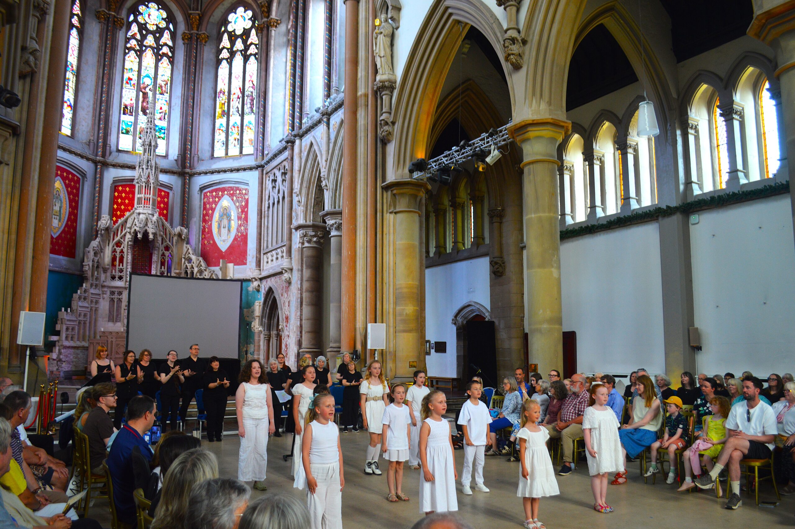 Performers and volunteers gather beneath the restored Great Nave following the sold-out performance of Rise Up, marking the Monastery's 30th anniversary.